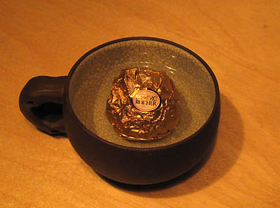 [Ferrero Rocher in a teacup filled with water]